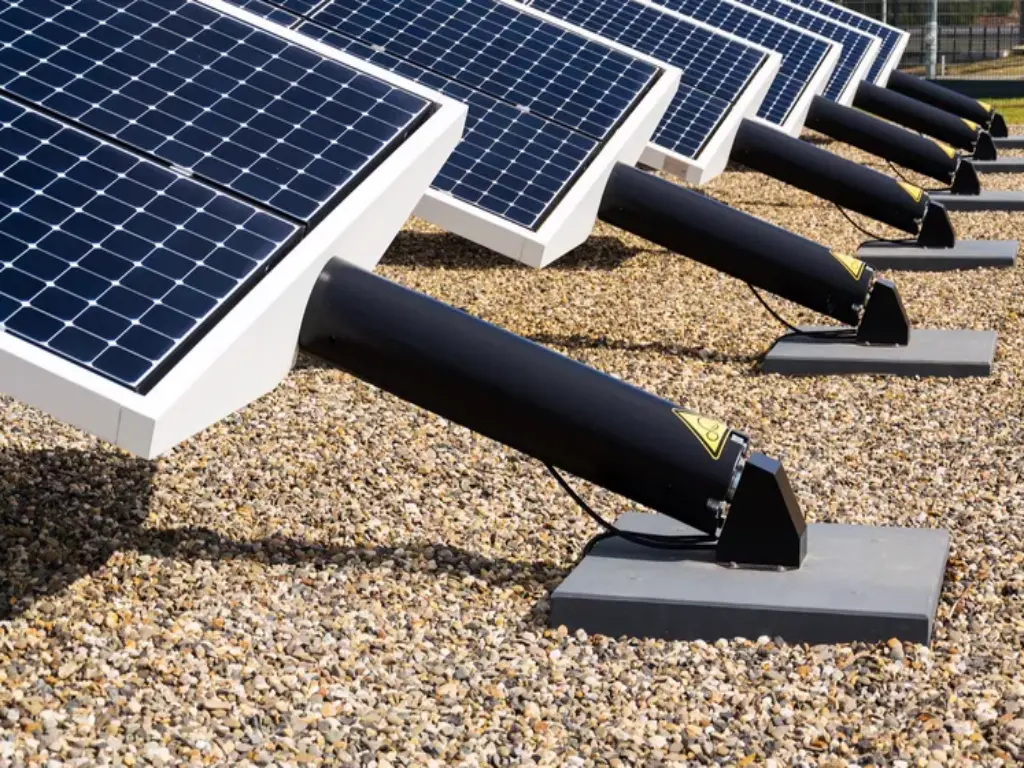 A row of solar panels on the ground.