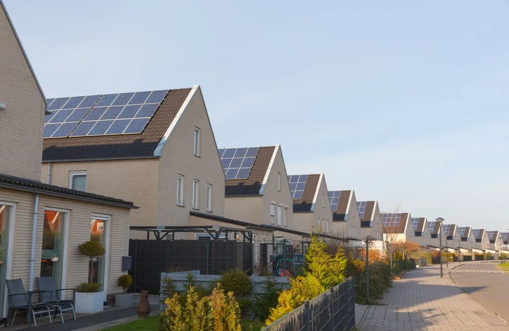 A residential street with solar panels installed on houses