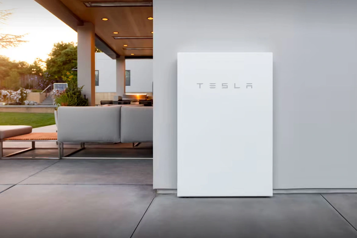 Tesla Powerwall mounted on the wall of the house.