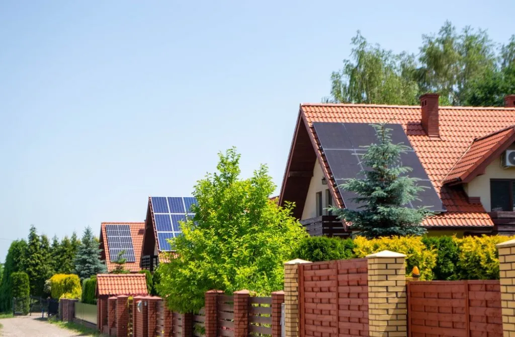 A row of cottage houses with installed solar panels.
