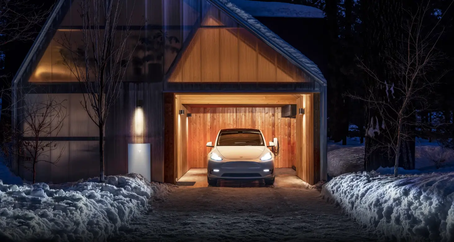 Tesla Powerfall installed in a house and charging an eco-friendly vehicle.