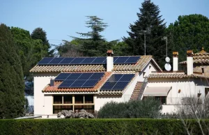 A house with installed solar panels on the roof in the village.