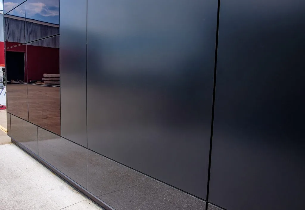 A black building facade with integrated photovoltaic solar cells.