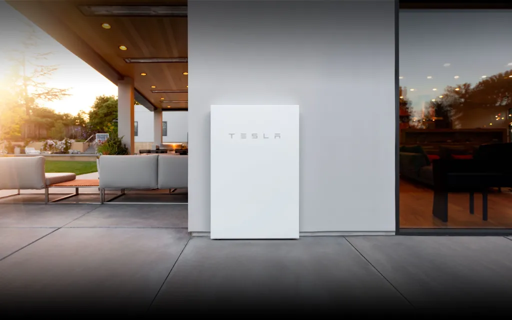 Tesla Powerwall mounted on the wall of the house.