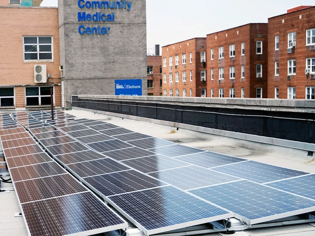 Solar panel installation on the roof of a medical facility building.