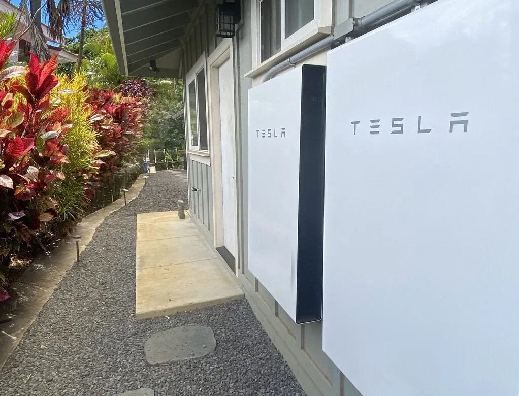 Tesla Powerwall mounted against a house wall